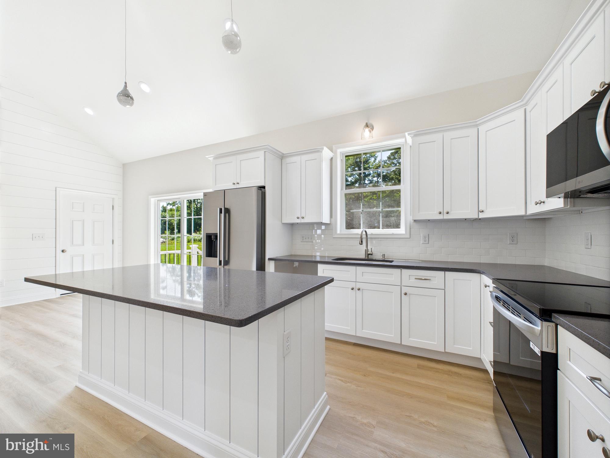 20168 Shingle Point Road Georgetown, DE 19947 - Photo 3 of 44 a kitchen with stainless steel appliances granite countertop a stove and a sink