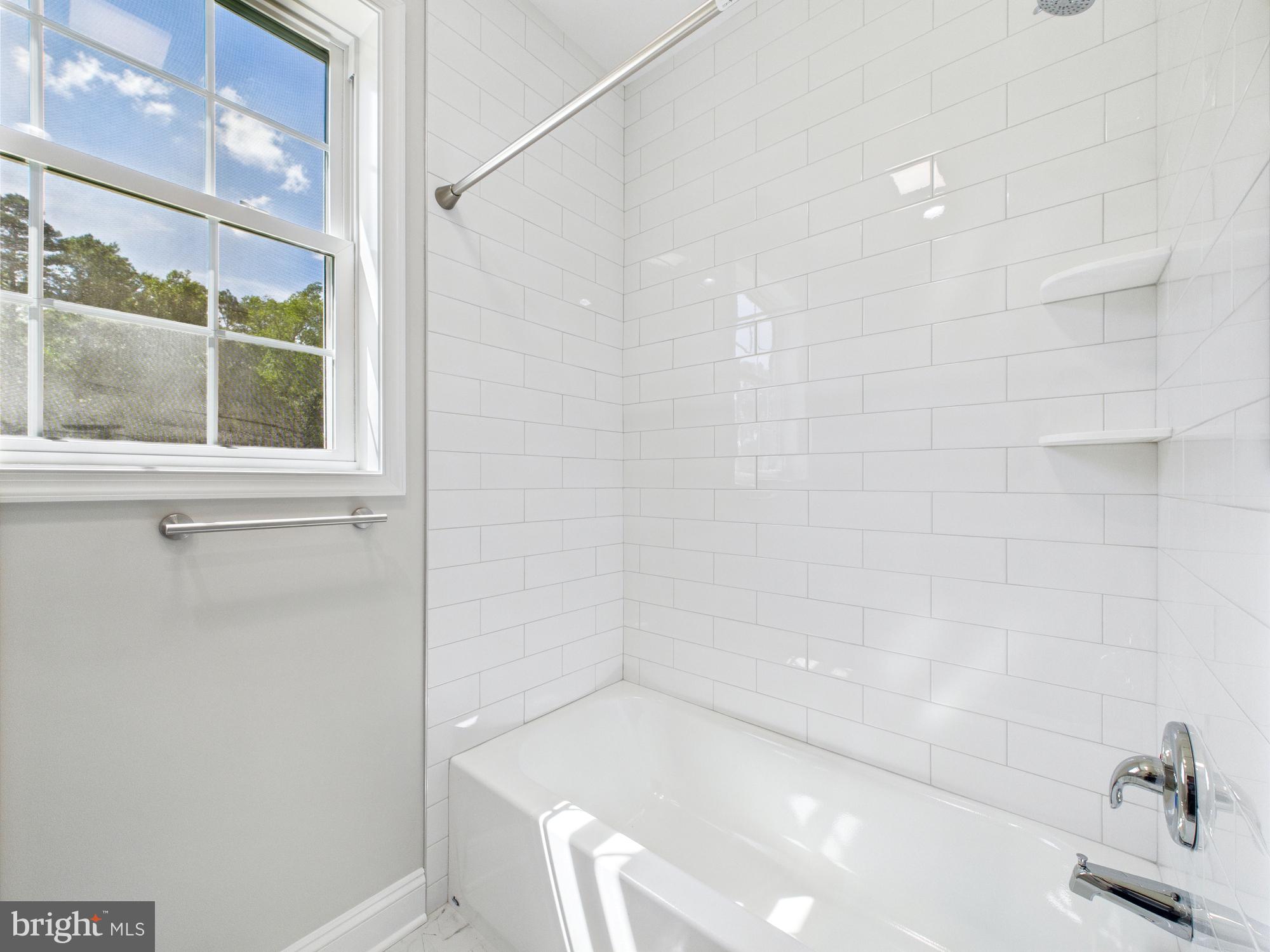 20168 Shingle Point Road Georgetown, DE 19947 - Photo 31 of 44 a bathroom with a bathtub and a window