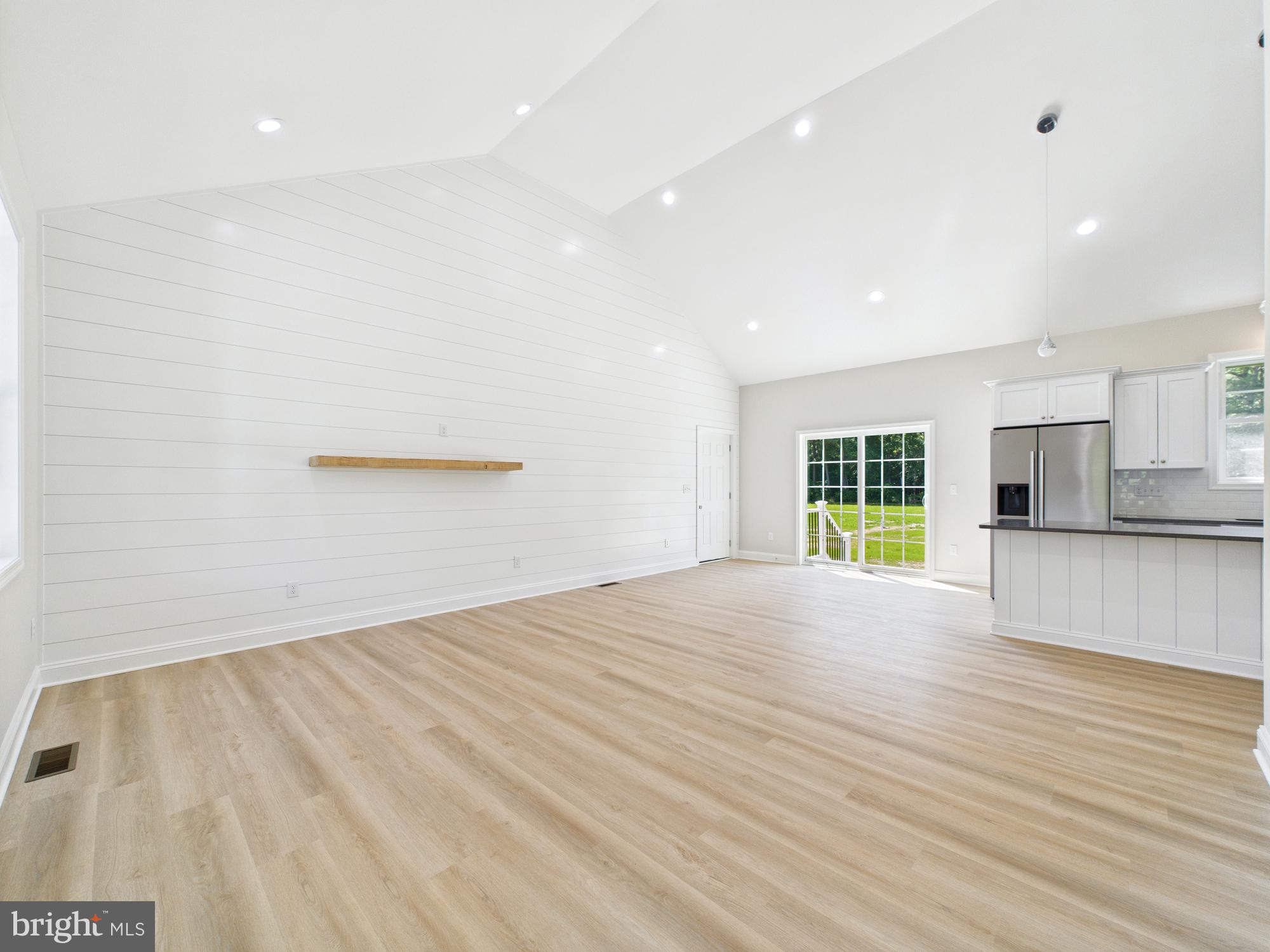 20168 Shingle Point Road Georgetown, DE 19947 - Photo 8 of 44 a view of empty room with wooden floor and windows