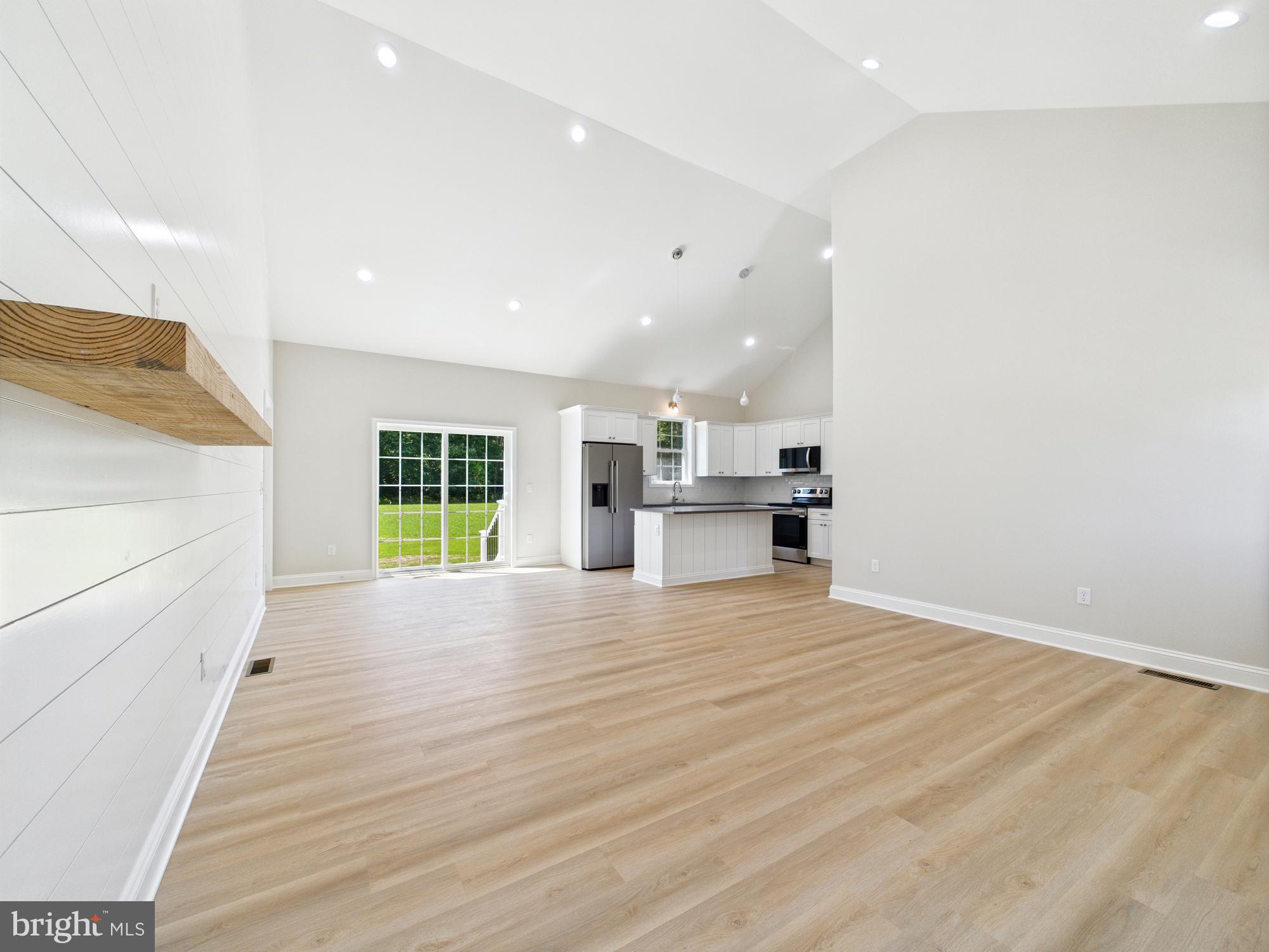 20168 Shingle Point Road Georgetown, DE 19947 - Photo 9 of 44 a view of an empty room with wooden floor and a window