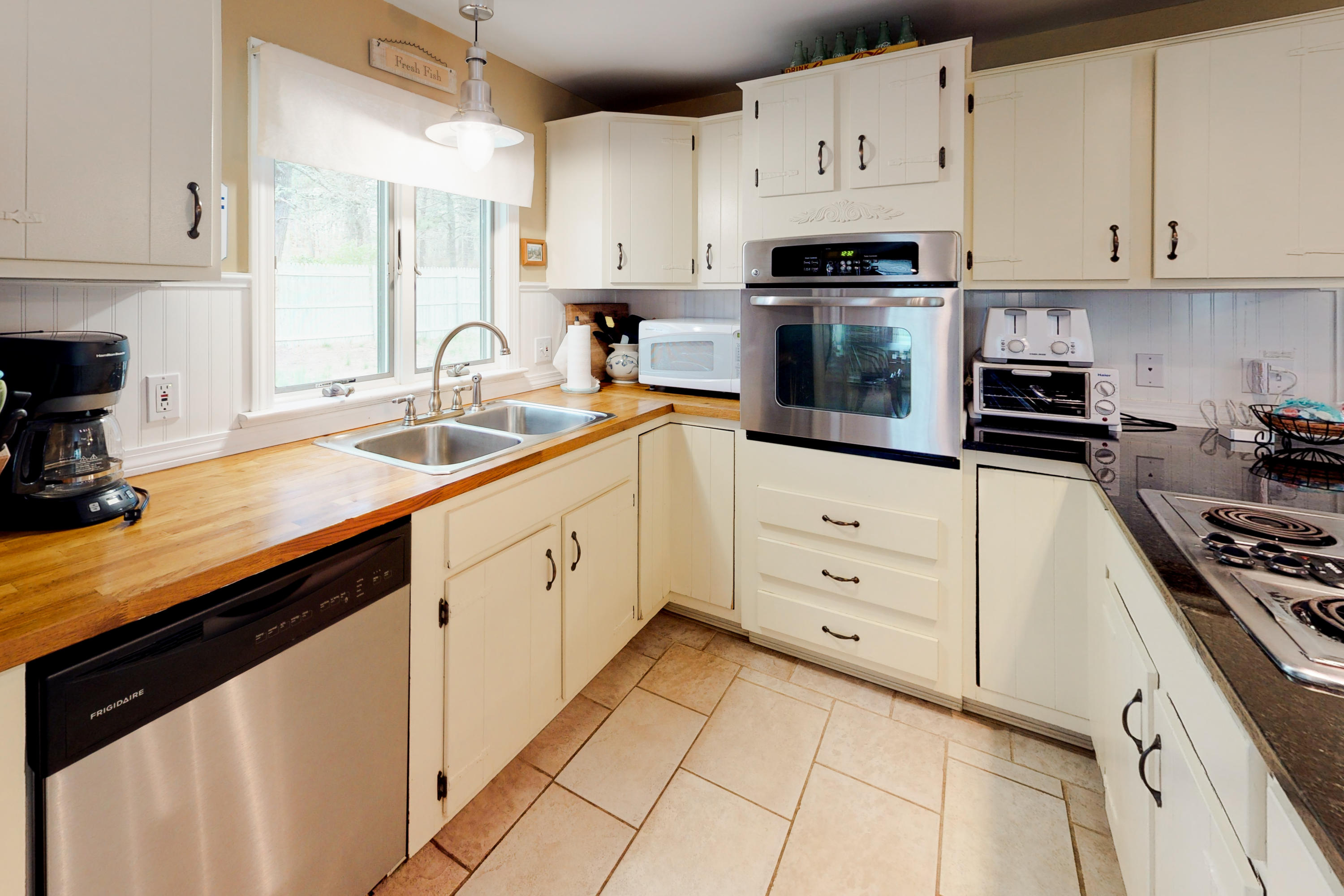 320 Cove View Road Wellfleet, MA 02667 - Photo 11 of 42 a kitchen with cabinets appliances a sink and a counter top