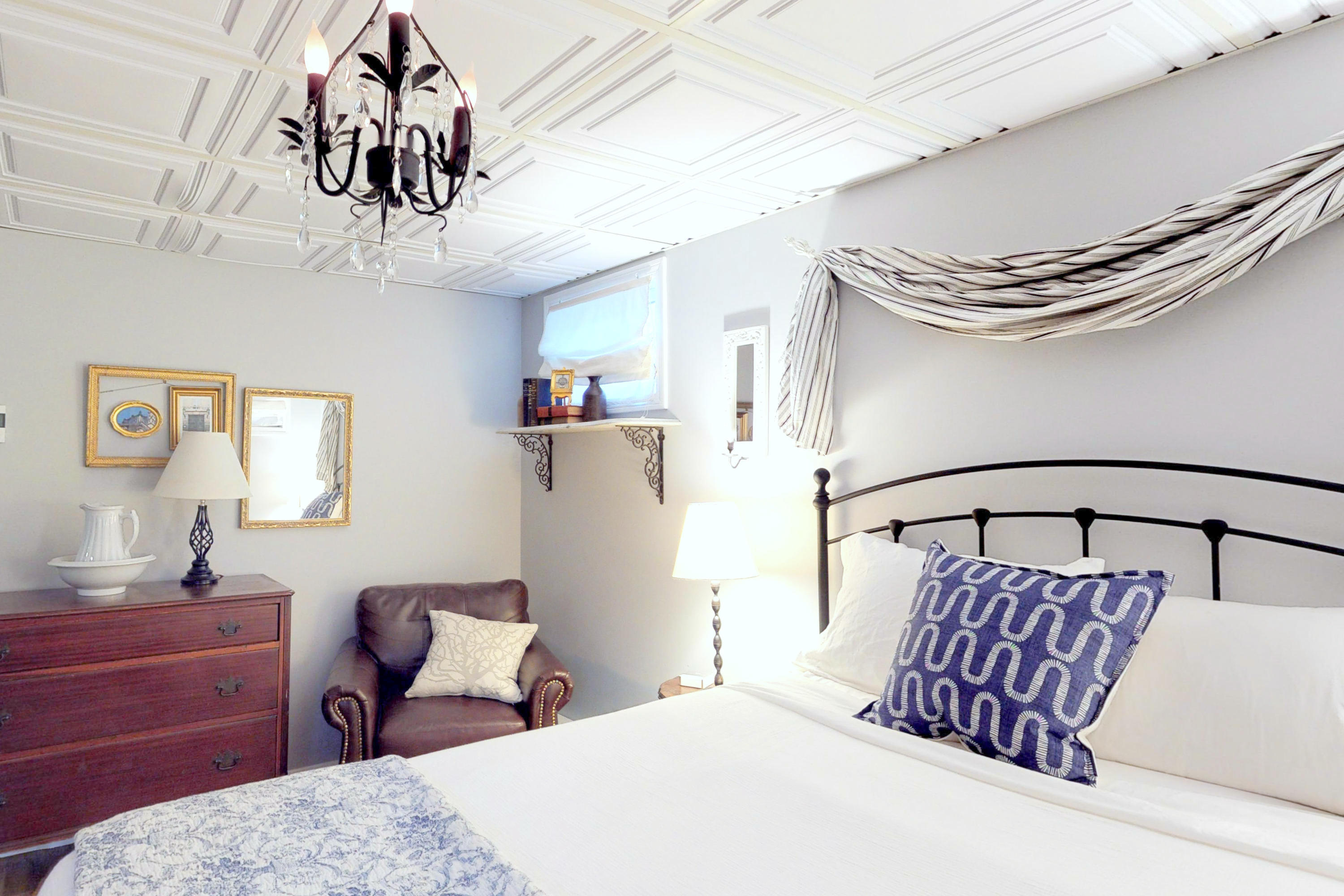 320 Cove View Road Wellfleet, MA 02667 - Photo 19 of 42 a bedroom with a large bed and a chandelier