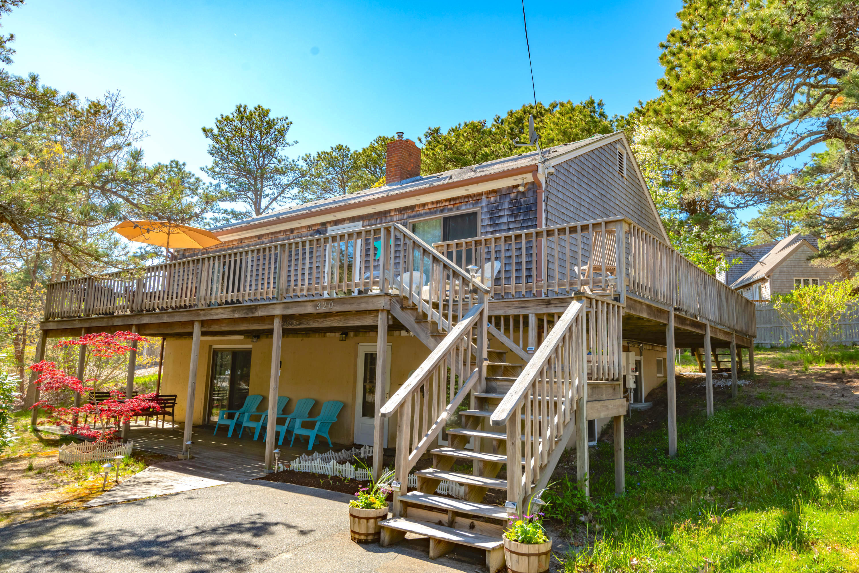 320 Cove View Road Wellfleet, MA 02667 - Photo 30 of 42 a front view of a house with a yard