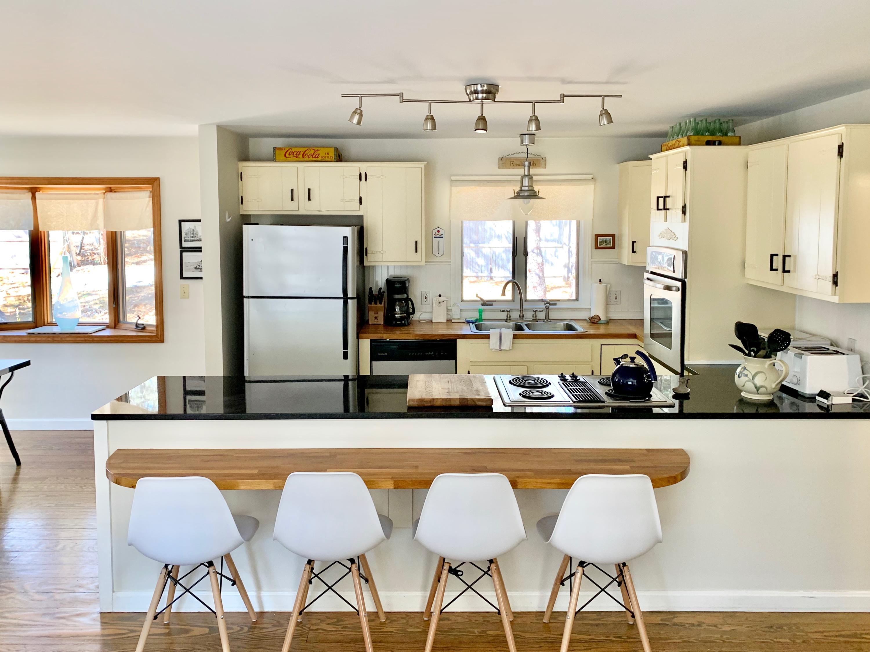 320 Cove View Road Wellfleet, MA 02667 - Photo 7 of 42 a kitchen with stainless steel appliances granite countertop a sink and a refrigerator