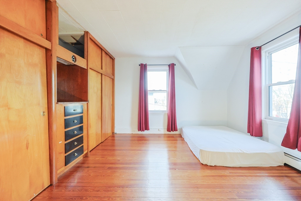 35 Miller Stile Road Quincy, MA 02169 - Photo 15 of 30 a view of an empty room with a window and wooden floor