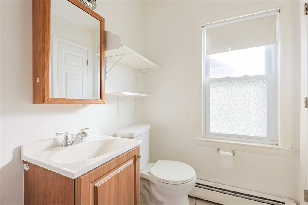 35 Miller Stile Road Quincy, MA 02169 - Photo 21 of 30 a bathroom with a sink a toilet and a mirror