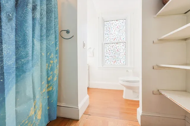 a bathroom with a toilet a sink and shower