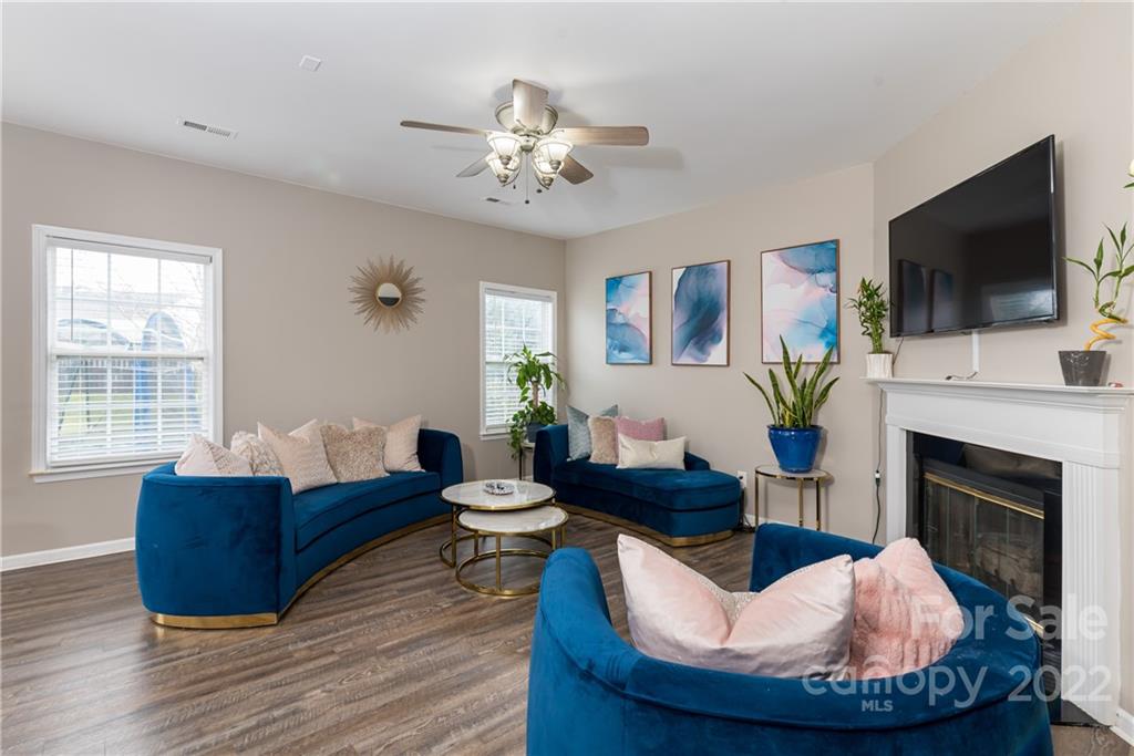 11429 Chapeclane Road Charlotte, NC 28278 - Photo 11 of 26 a living room with furniture a flat screen tv and a fireplace