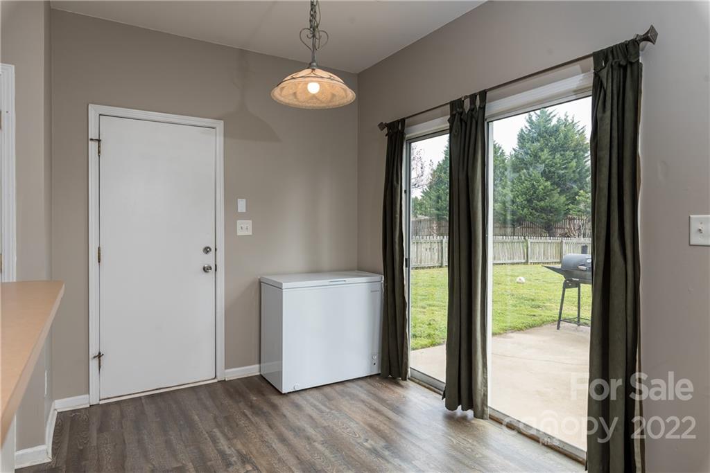 11429 Chapeclane Road Charlotte, NC 28278 - Photo 12 of 26 a view of an empty room with wooden floor and a window