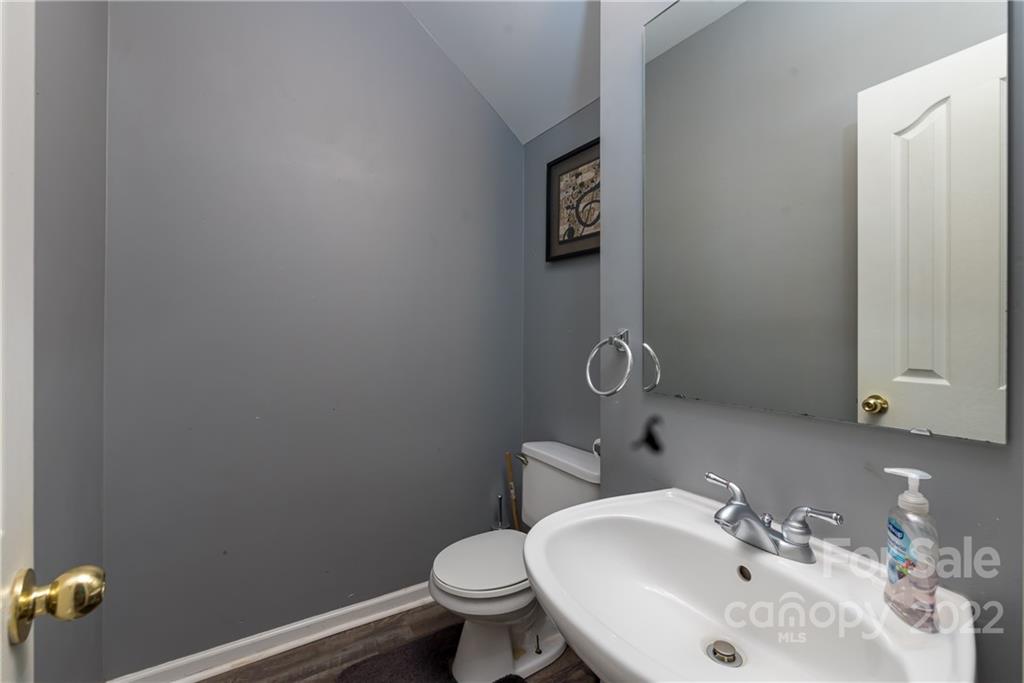 11429 Chapeclane Road Charlotte, NC 28278 - Photo 13 of 26 a bathroom with a sink and toilet
