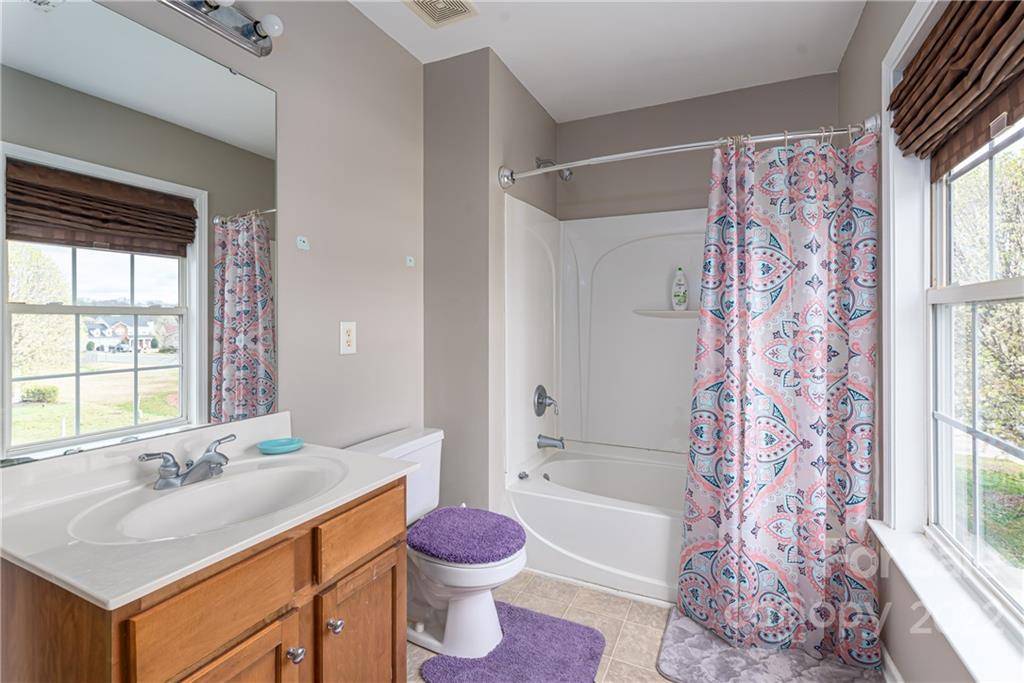 11429 Chapeclane Road Charlotte, NC 28278 - Photo 15 of 26 a bathroom with a sink toilet tub and shower