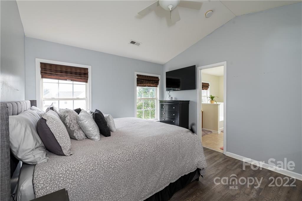 11429 Chapeclane Road Charlotte, NC 28278 - Photo 19 of 26 a bedroom with a bed and a fireplace