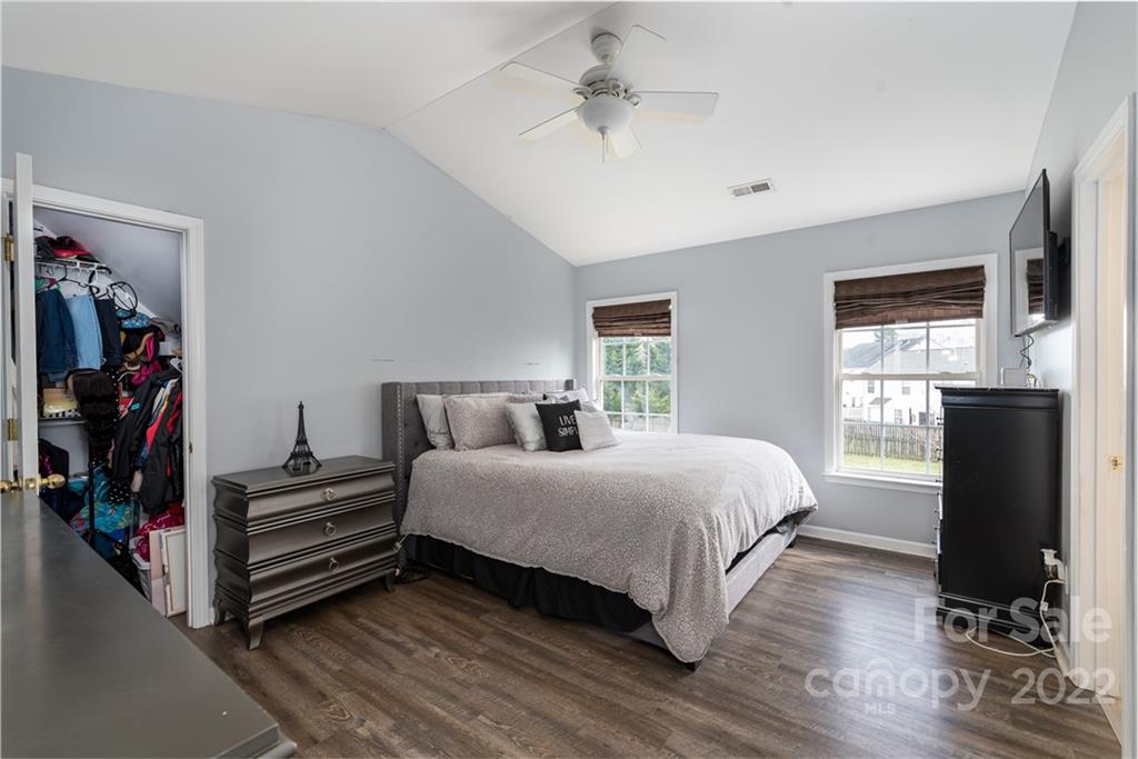 11429 Chapeclane Road Charlotte, NC 28278 - Photo 20 of 26 a bedroom with a bed and a chandelier