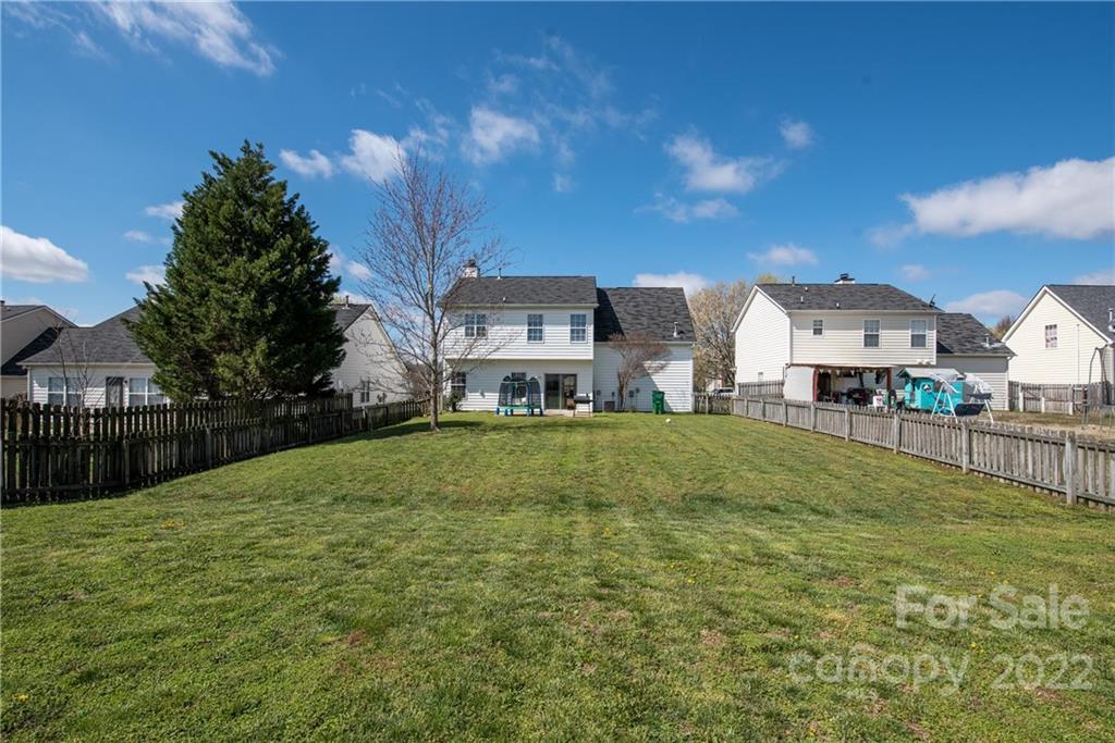 11429 Chapeclane Road Charlotte, NC 28278 - Photo 22 of 26 a view of a big house with a big yard and large trees