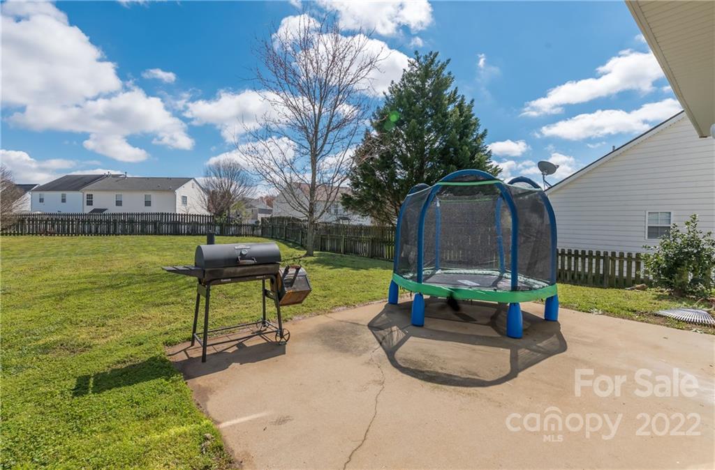 11429 Chapeclane Road Charlotte, NC 28278 - Photo 24 of 26 a view of a garden with a bench and some trees