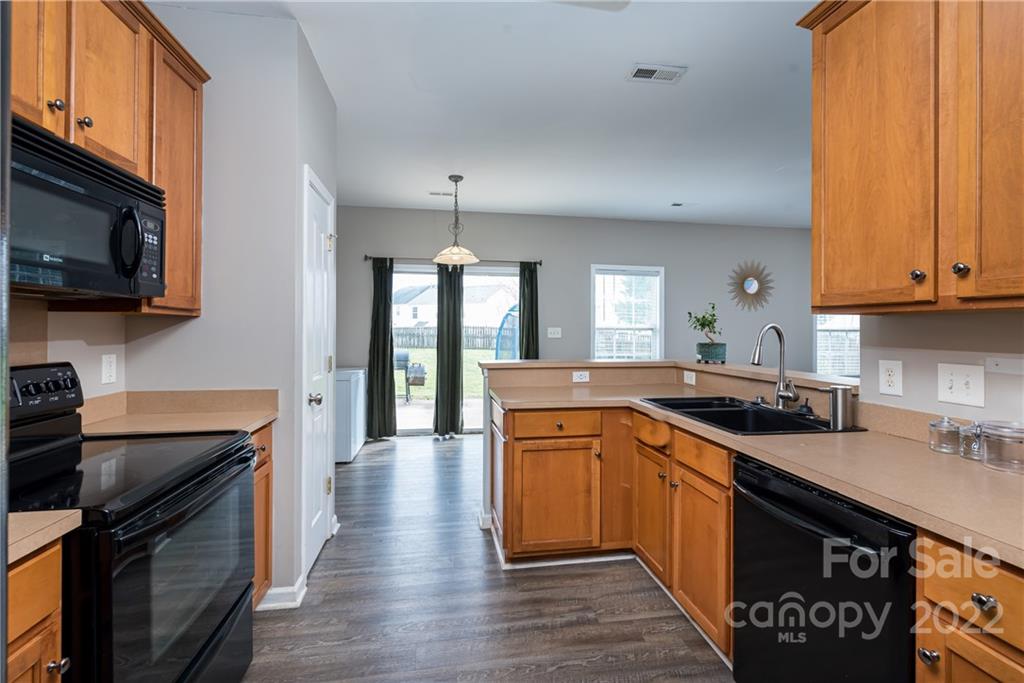 11429 Chapeclane Road Charlotte, NC 28278 - Photo 6 of 26 a kitchen with stainless steel appliances granite countertop a sink stove and cabinets