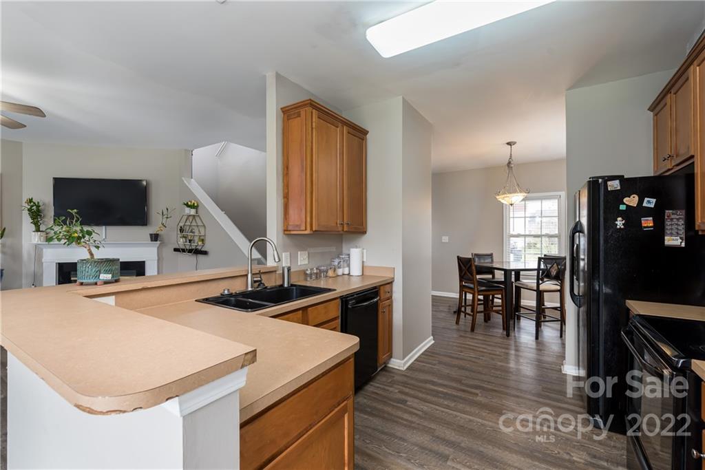11429 Chapeclane Road Charlotte, NC 28278 - Photo 8 of 26 a kitchen with stainless steel appliances kitchen island granite countertop a sink a stove and cabinets