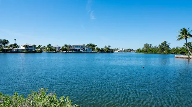 an aerial view of a house with outdoor space and lake view