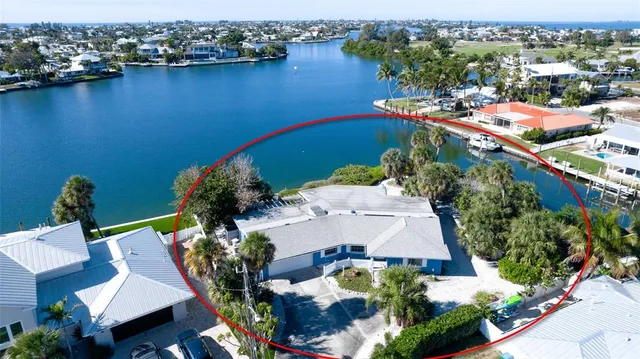 an aerial view of a house with a yard basket ball court and outdoor seating