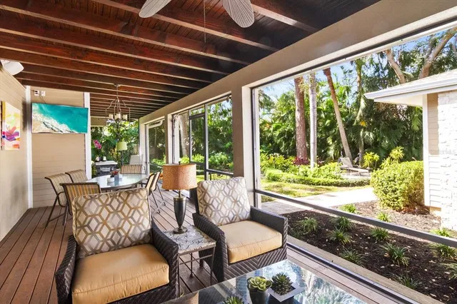a view of a patio with table and chairs and wooden floor