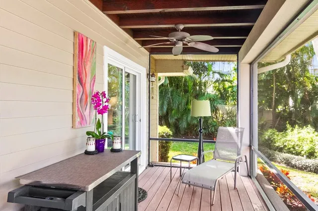 a view of a porch with furniture and a yard