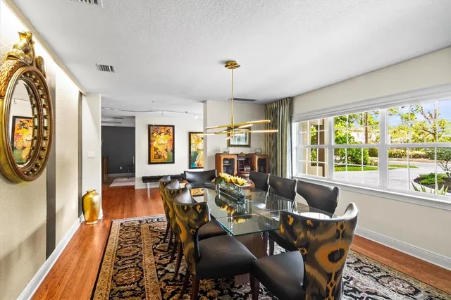 a bedroom with a bed and a lamp on the dresser