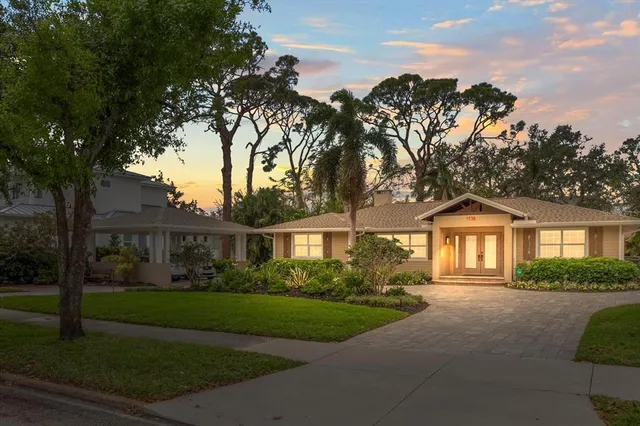 a front view of a house with a garden