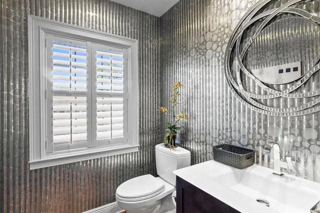 a kitchen with stainless steel appliances kitchen island granite countertop a refrigerator a stove and a sink with wooden floor