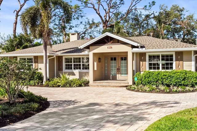 a front view of a house with a yard and outdoor seating