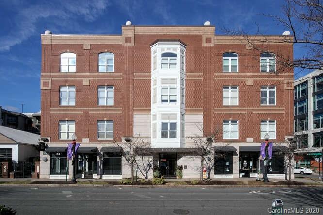 a front view of a brick building with many windows
