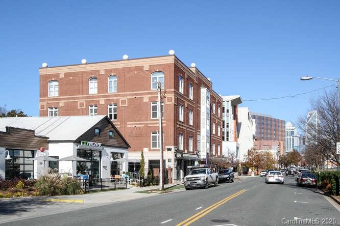 1700 Camden Road, Unit 201 Charlotte, NC 28203 - Photo 22 of 30 a city street lined with parked cars and buildings