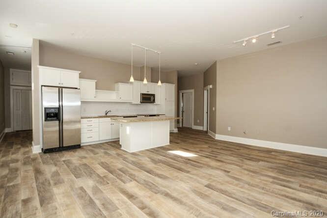1700 Camden Road, Unit 201 Charlotte, NC 28203 - Photo 8 of 30 a large kitchen with cabinets and stainless steel appliances