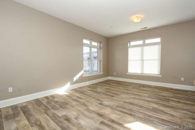 1700 Camden Road, Unit 201 Charlotte, NC 28203 - Photo 10 of 30 an empty room with wooden floor and windows