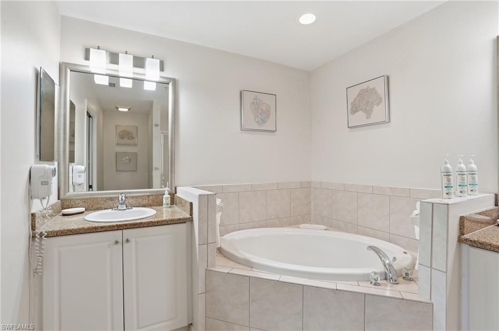 7920 Mahogany Run Lane, Unit 1015 Naples, FL 34113 - Photo 22 of 35 ENSUITE SPA BATH WITH SOAKING TUB AND DUAL SINKS..