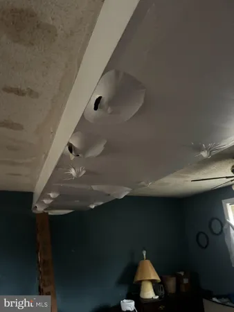 a room with water heater and wooden cabinets