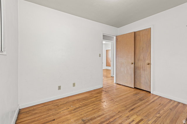 542 East 3400th Street North Provo, UT 84604 - Photo 20 of 39 Room with wood-finish flooring, light-toned walls, and a window providing natural light