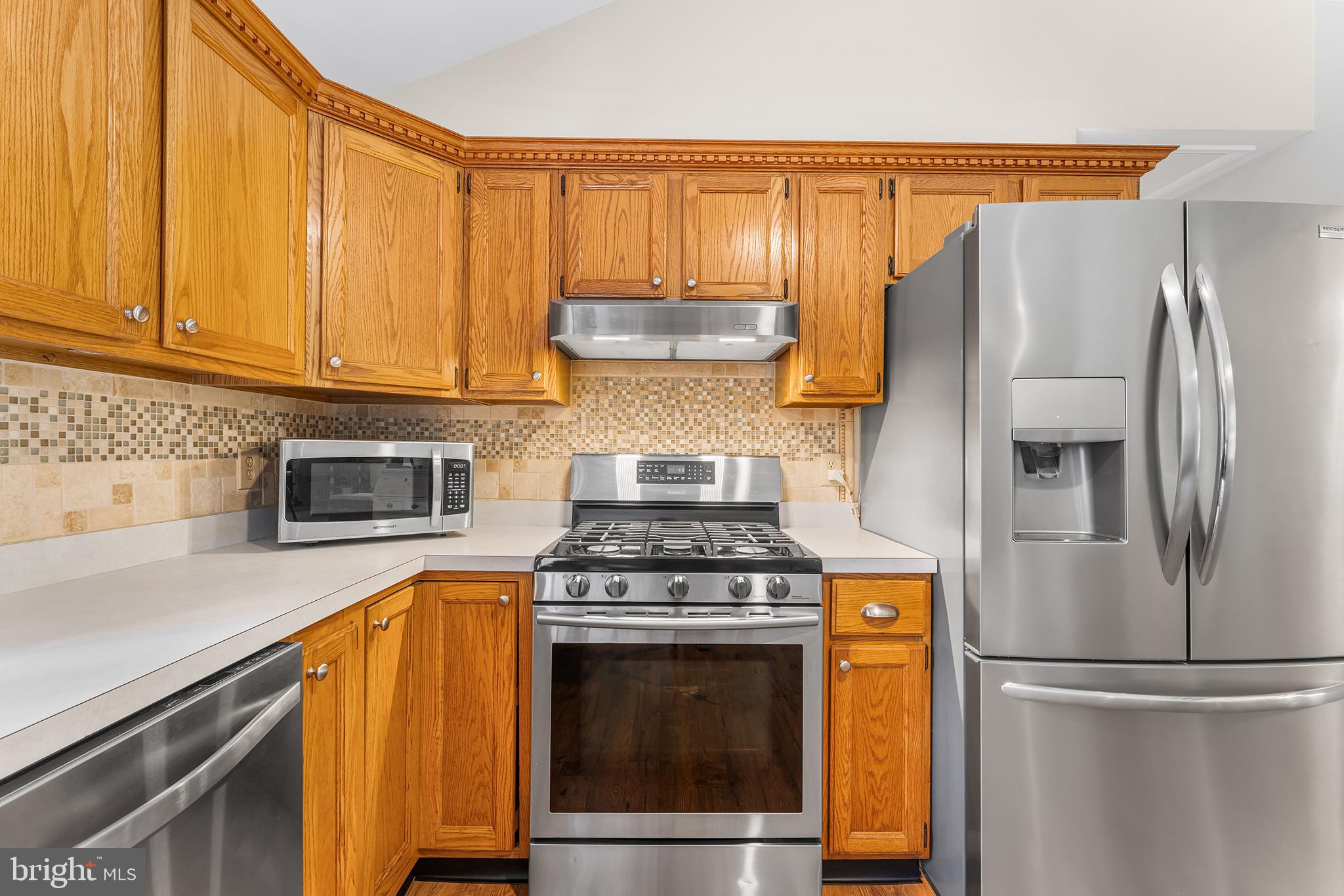 1431 Burleigh Road Cape May Court House, NJ 08210 - Photo 15 of 35 a kitchen with granite countertop a stove and a refrigerator