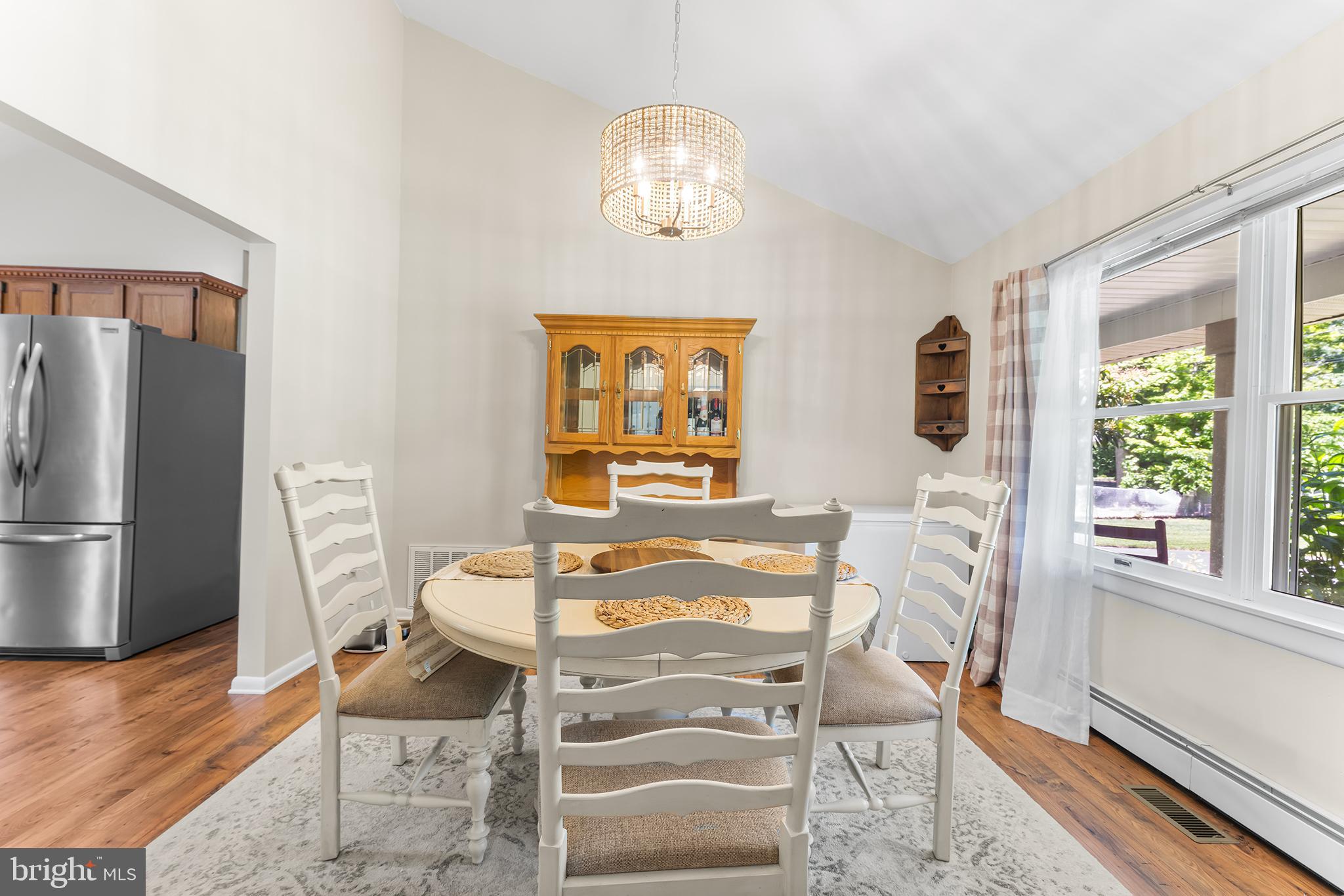 1431 Burleigh Road Cape May Court House, NJ 08210 - Photo 16 of 35 a dining room with furniture a chandelier and wooden floor