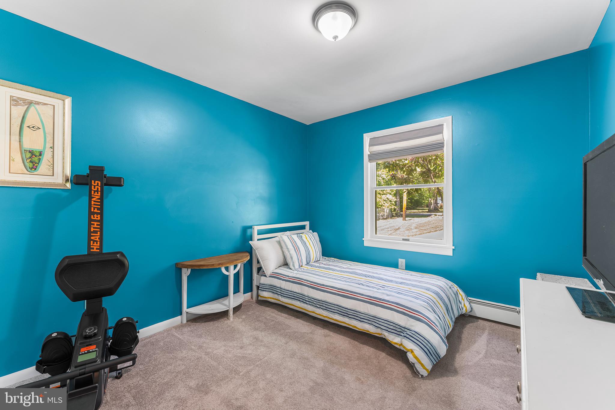 1431 Burleigh Road Cape May Court House, NJ 08210 - Photo 28 of 35 a bedroom with a bed and a chandelier