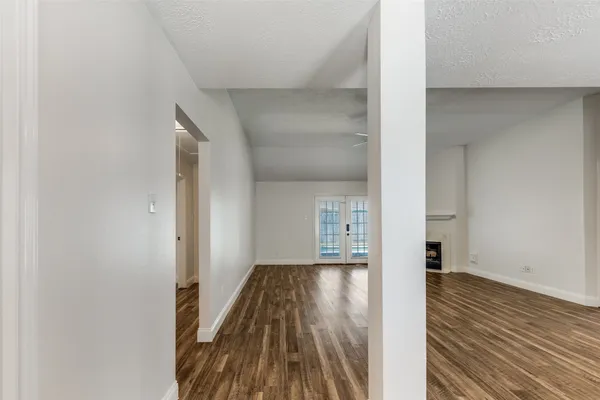 wooden floor in an empty room with a fireplace