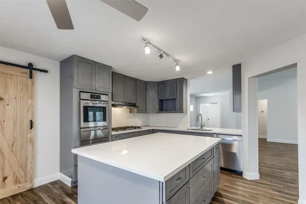 a kitchen with a sink and refrigerator
