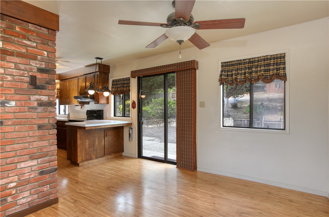 910 North 12th Street Grover Beach, CA 93433 - Photo 12 of 42 a kitchen with stainless steel appliances kitchen island granite countertop a refrigerator a stove and a wooden floors