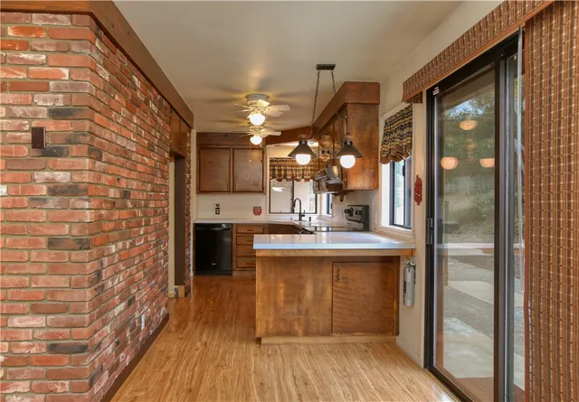 a kitchen with kitchen island a sink appliances and cabinets