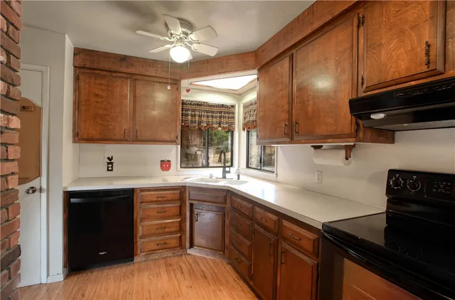 a kitchen with a sink a stove and cabinets