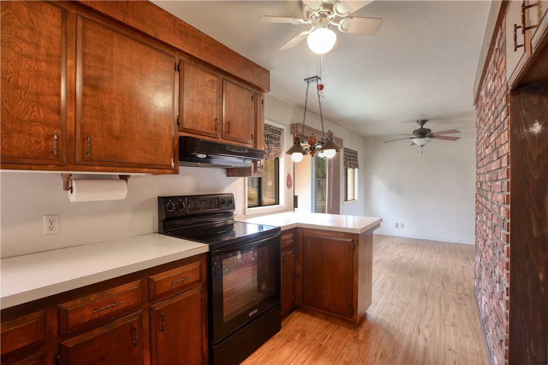 910 North 12th Street Grover Beach, CA 93433 - Photo 16 of 42 a kitchen with granite countertop wooden cabinets and white appliances