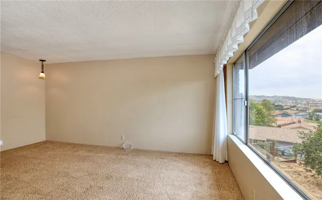 a view of an empty room and a window