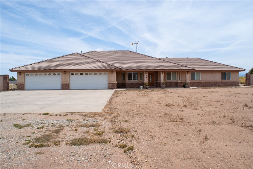 8465 Cedar Court Phelan, CA 92371 - Photo 1 of 51 a large house with a big yard and large trees