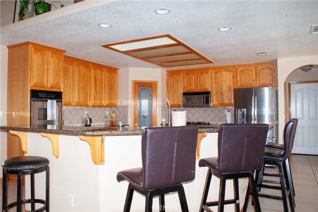 8465 Cedar Court Phelan, CA 92371 - Photo 34 of 51 a dining table with chairs and kitchen view