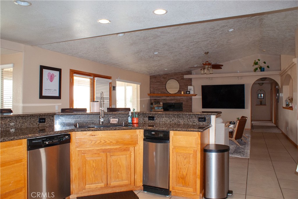 8465 Cedar Court Phelan, CA 92371 - Photo 36 of 51 a kitchen with stainless steel appliances granite countertop a stove a sink and a microwave