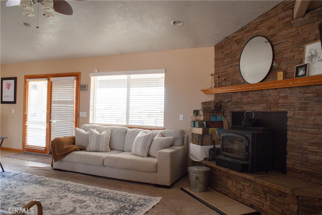 8465 Cedar Court Phelan, CA 92371 - Photo 39 of 51 a living room with furniture a large window and a fireplace